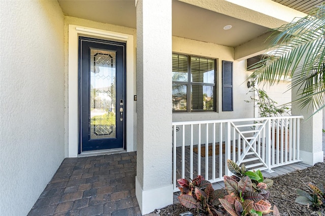 property entrance with stucco siding