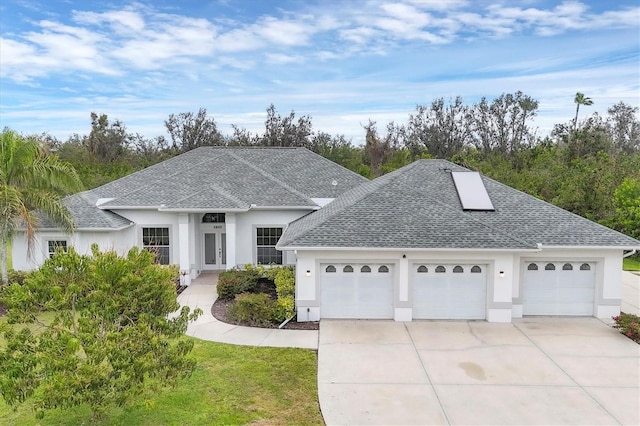 view of front of house featuring a garage, stucco siding, concrete driveway, and roof with shingles