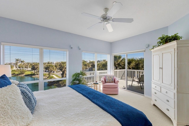 bedroom with light carpet, access to exterior, and a ceiling fan