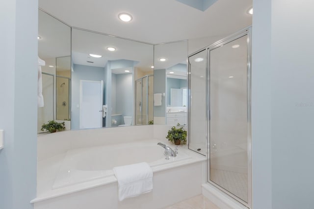 bathroom featuring a bath, recessed lighting, and a shower stall