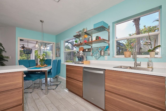 kitchen with a sink, light countertops, dishwasher, modern cabinets, and brown cabinets