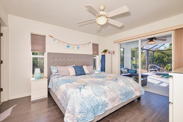 bedroom featuring dark wood-style floors, access to exterior, a ceiling fan, and a sunroom