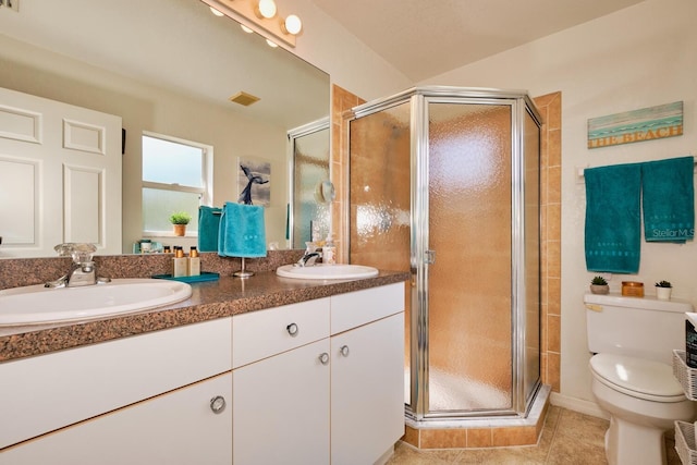 full bath featuring a stall shower, toilet, and a sink