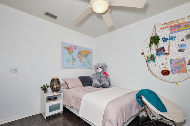 bedroom with visible vents, baseboards, dark wood-type flooring, and a ceiling fan