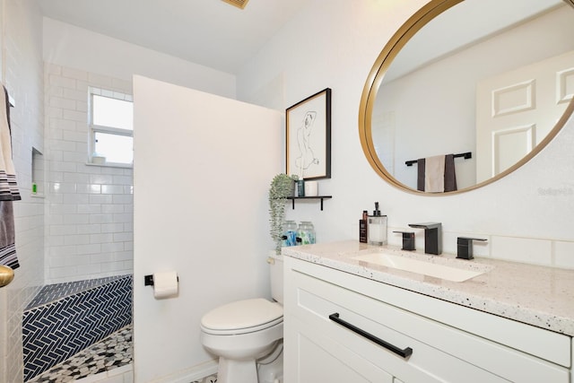 full bathroom featuring toilet, vanity, and a walk in shower