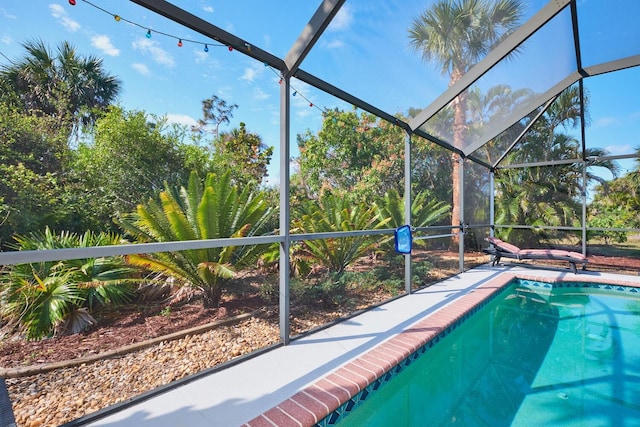 outdoor pool with a lanai and a patio area