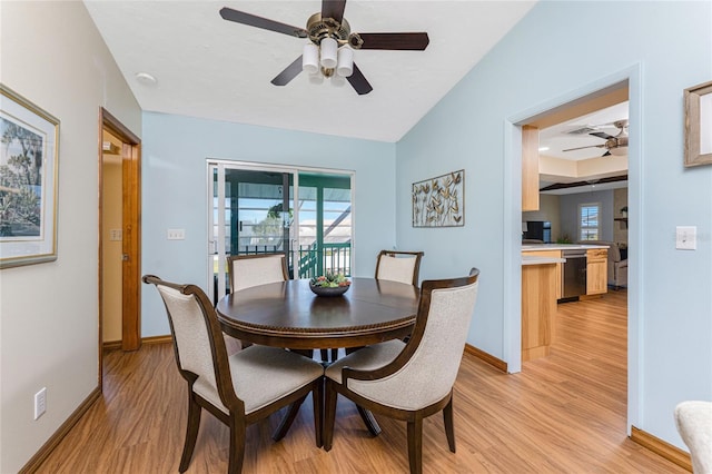 dining space with a ceiling fan, light wood-style floors, and baseboards