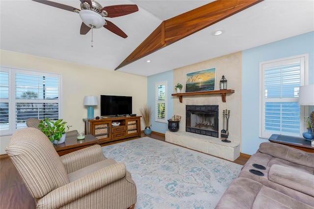 living room with a healthy amount of sunlight, a fireplace, a ceiling fan, and lofted ceiling