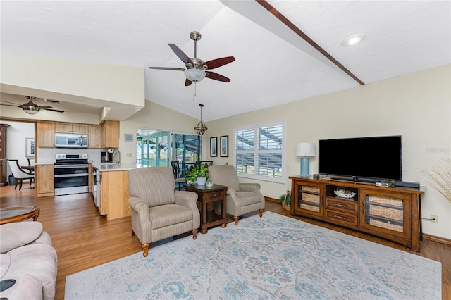 living area featuring light wood-type flooring, baseboards, ceiling fan, and vaulted ceiling