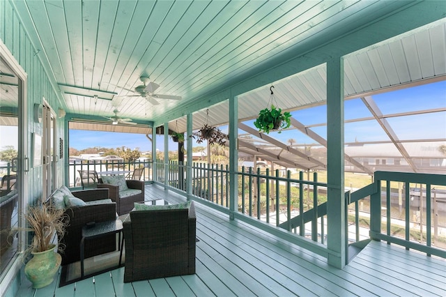 wooden deck featuring an outdoor hangout area and a ceiling fan