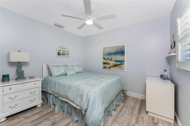 bedroom with visible vents, baseboards, light wood-style floors, and a ceiling fan