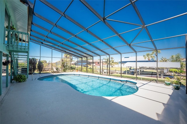 pool with glass enclosure, stairs, and a patio