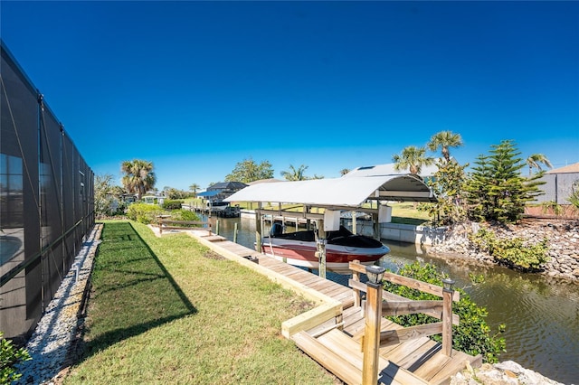 view of yard with a boat dock, glass enclosure, a water view, and boat lift