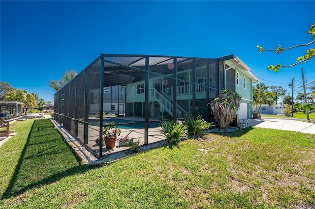 view of side of property featuring driveway, a patio, glass enclosure, an attached garage, and an outdoor pool