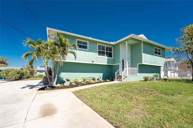 bi-level home with a front lawn