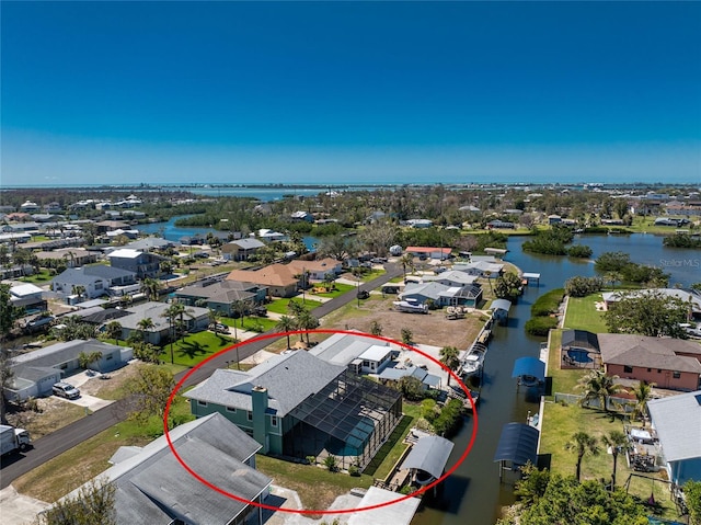 birds eye view of property with a water view and a residential view