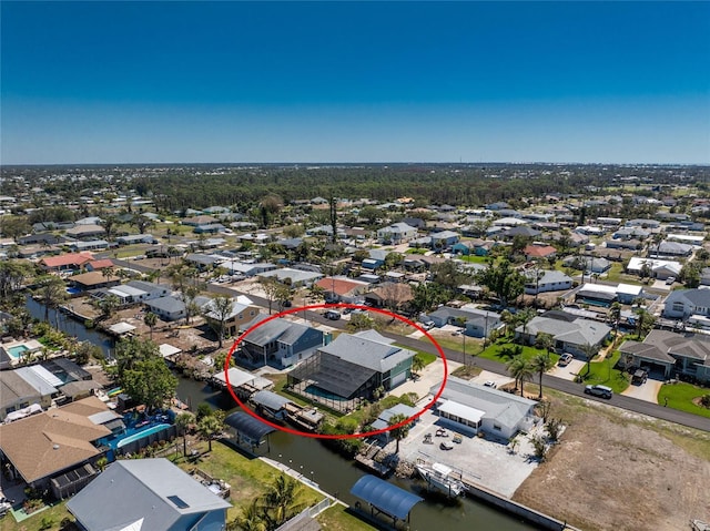 birds eye view of property with a residential view and a water view