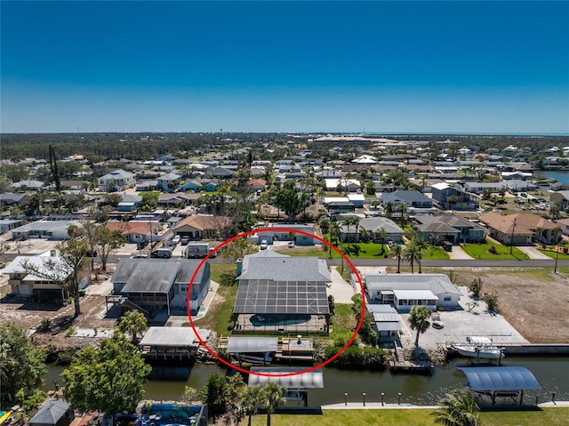 drone / aerial view featuring a residential view and a water view