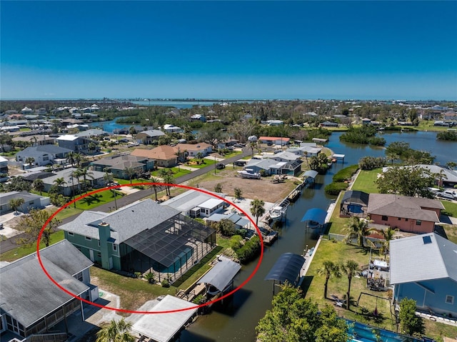 bird's eye view featuring a water view and a residential view