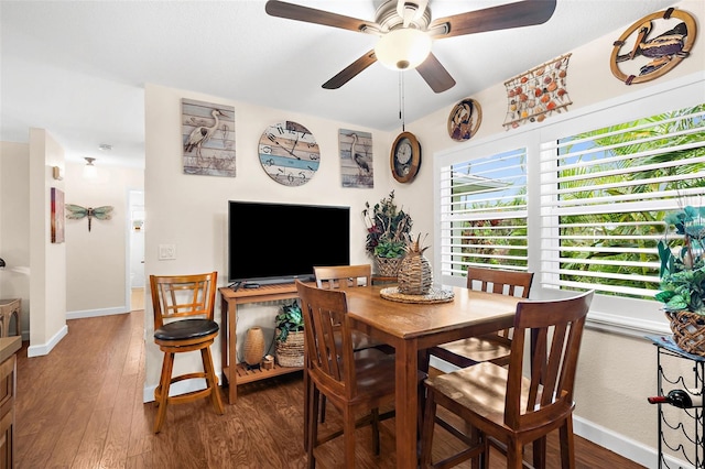 dining room with baseboards, wood finished floors, and a ceiling fan