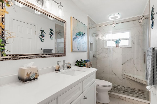 bathroom with a marble finish shower, marble finish floor, toilet, and vanity