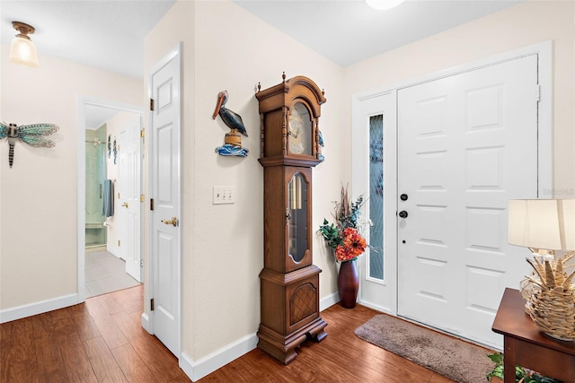 foyer featuring baseboards and hardwood / wood-style flooring