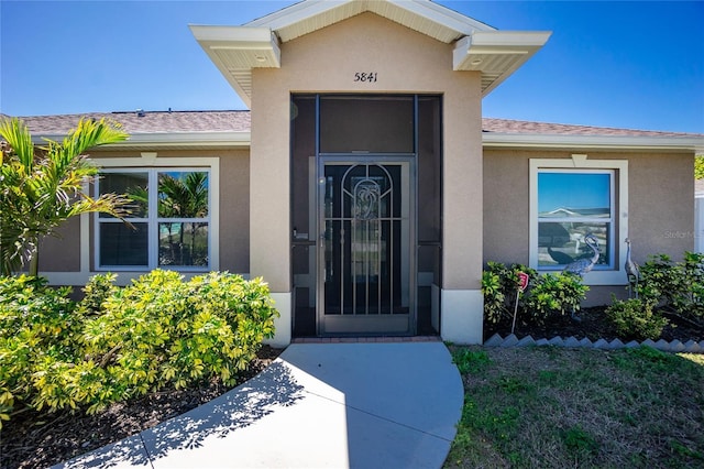 doorway to property with stucco siding