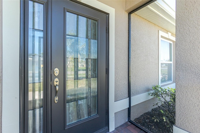 doorway to property with stucco siding