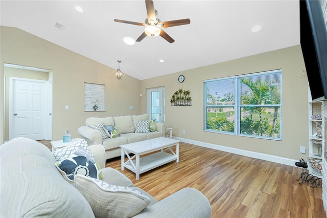 living area featuring visible vents, baseboards, lofted ceiling, recessed lighting, and wood finished floors