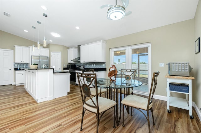 dining area with visible vents, recessed lighting, baseboards, light wood finished floors, and lofted ceiling