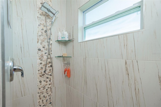 full bath with a tile shower