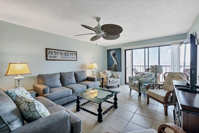 living room with light tile patterned floors, a textured ceiling, and ceiling fan