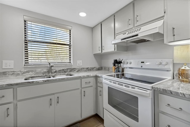 kitchen featuring electric stove, under cabinet range hood, a sink, recessed lighting, and tile patterned flooring