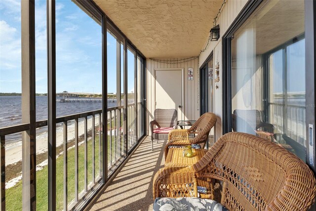 sunroom / solarium with a water view