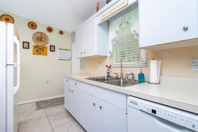 kitchen featuring a sink, decorative backsplash, white appliances, and light countertops