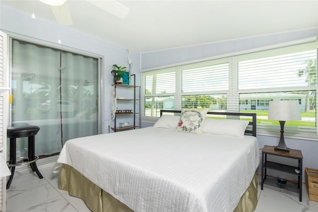 bedroom featuring a ceiling fan, marble finish floor, and a closet