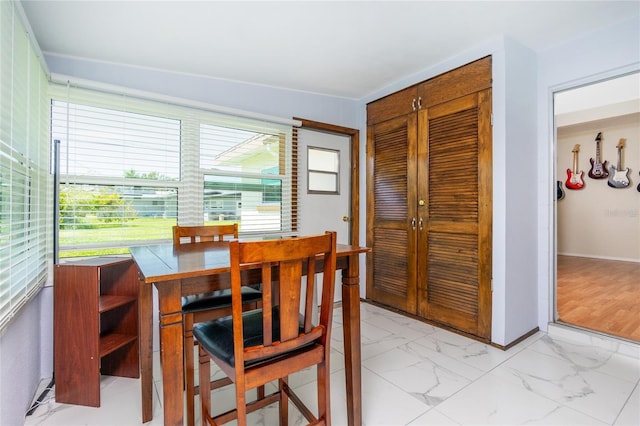 dining room featuring baseboards and marble finish floor