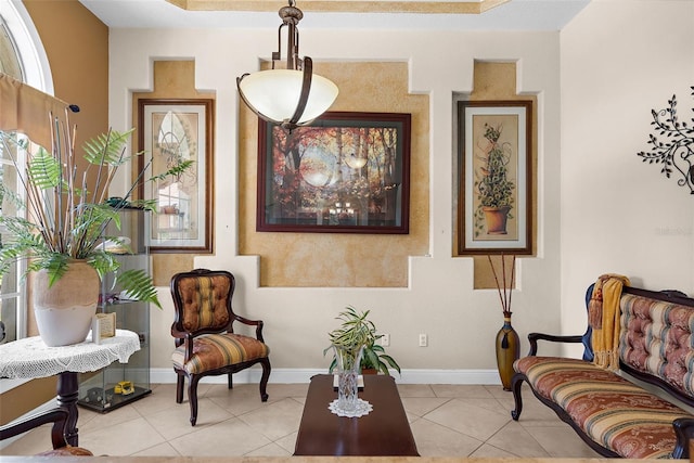 living area with light tile patterned flooring and baseboards