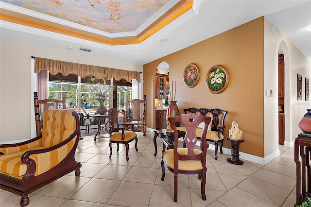 interior space featuring light tile patterned floors, visible vents, a tray ceiling, arched walkways, and crown molding