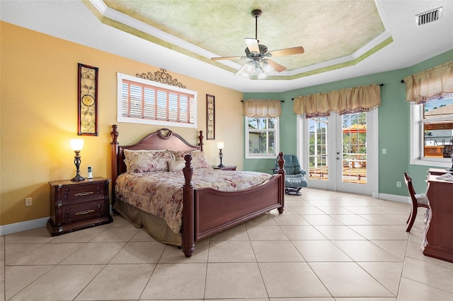 bedroom featuring visible vents, baseboards, a textured ceiling, a raised ceiling, and access to outside