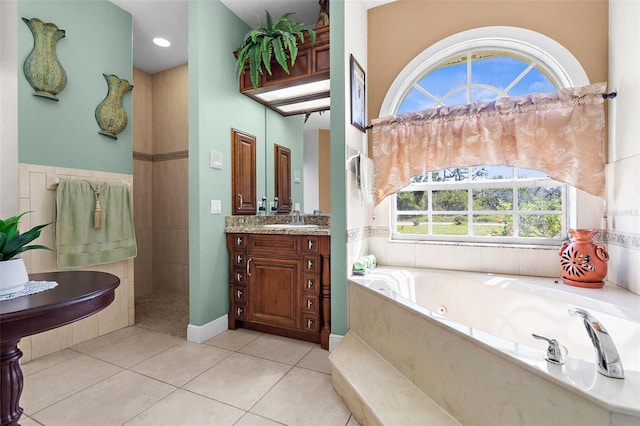 full bathroom with a bath, tile patterned flooring, and vanity