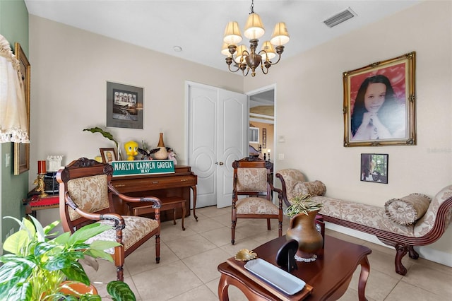 living area with light tile patterned floors, visible vents, and a chandelier