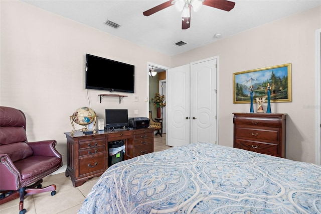 bedroom featuring tile patterned floors, visible vents, and a ceiling fan