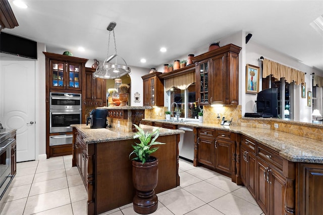 kitchen featuring decorative backsplash, a warming drawer, light tile patterned floors, and stainless steel appliances