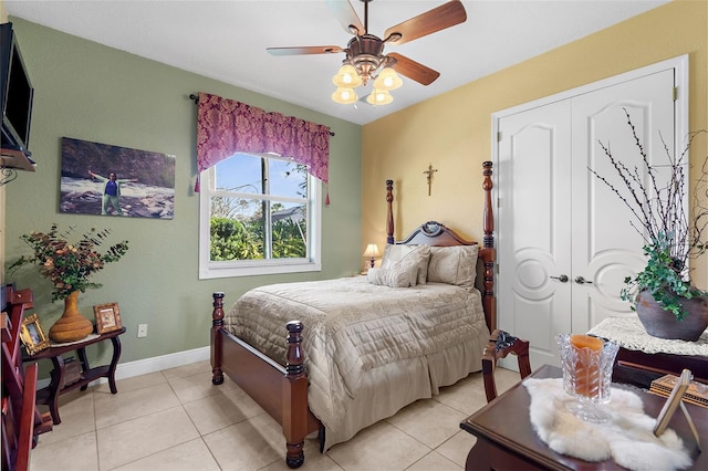 bedroom with light tile patterned floors, baseboards, and a ceiling fan