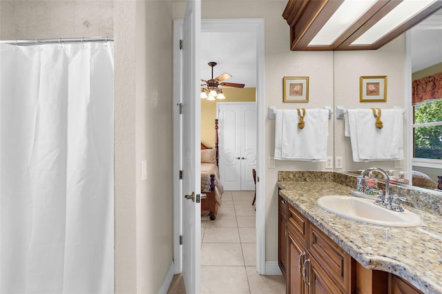 ensuite bathroom with tile patterned flooring, curtained shower, vanity, ensuite bath, and a ceiling fan