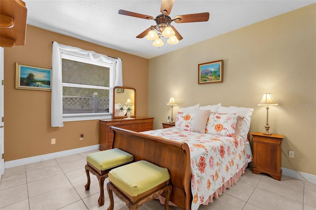 bedroom featuring light tile patterned flooring, a ceiling fan, and baseboards