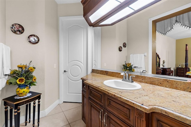 bathroom featuring tile patterned flooring, vanity, and baseboards