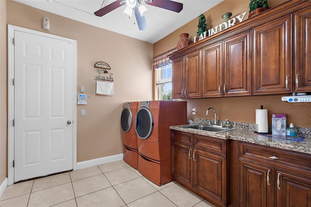 laundry area featuring washer and clothes dryer, light tile patterned flooring, cabinet space, a ceiling fan, and a sink