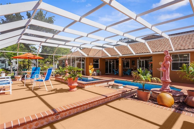 view of swimming pool with glass enclosure, a patio, and a pool with connected hot tub